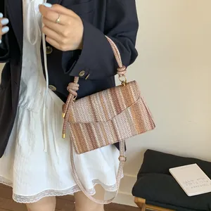 Colorful woven crossbody bag with knotted handle and adjustable strap for women