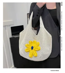 Detail of hand-woven cream tote bag with large 3D yellow crochet flower on soft knit fabric