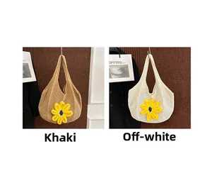 Detail of woven tote bags in khaki and cream with yellow floral accents for summer fashion