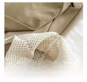 Detail of the easy opening and intricate hand-woven crochet texture on the white tote bag
