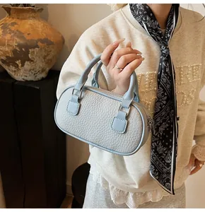 Close-up of light blue bowling bag featuring premium lychee texture and silver hardware
