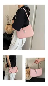 Detail of pink hobo bag featuring a silver metal piston buckle and woven texture