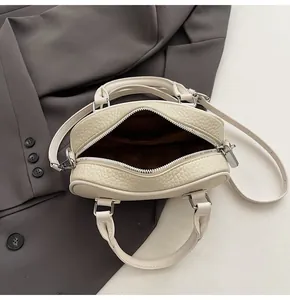 Top view of cream bowling bag with pebble leather texture and spacious inner lining