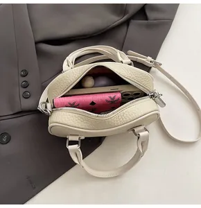 Top view of beige lychee leather mini Boston bag showing internal storage space