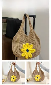 Detail view of khaki woven tote bag featuring a large yellow floral applique for summer