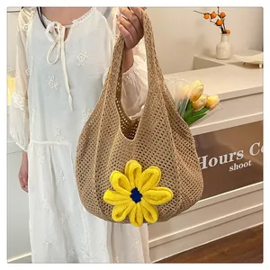 Detailed macro view of a handmade crochet tote bag with a 3D yellow sunflower embellishment