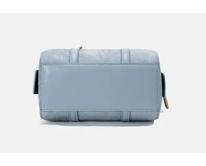 Detail of light blue Boston bag base showing reinforced leather straps and twill texture