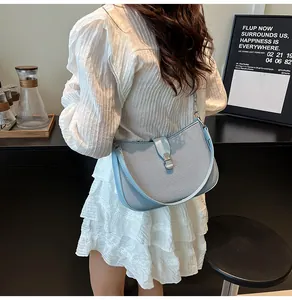 Close-up of the light blue woven texture and silver buckle on a stylish shoulder bag