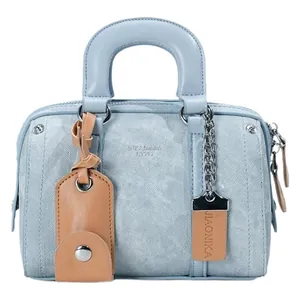 Light blue Boston handbag with embossed texture, brown leather charms, and silver zippers