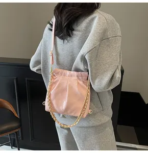 Detail of pink quilted leather bag with gold chain and adjustable shoulder strap