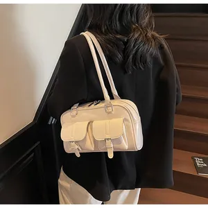 Rear view of a model wearing a beige large-capacity tote bag on a wooden staircase