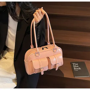 Detail of pink patent leather tote with functional pockets and silver-tone hardware