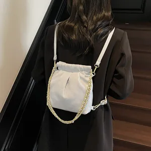 Quilted light grey drawstring backpack with golden chain and adjustable straps for women