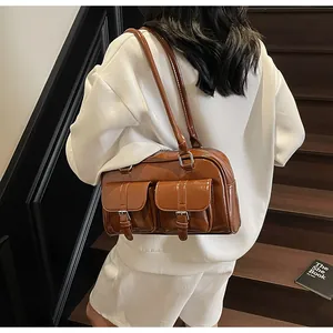 Macro detail of glossy caramel patent leather tote bag with silver buckle pockets