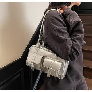 Metallic silver tote bag with double front buckle pockets and sleek shoulder straps