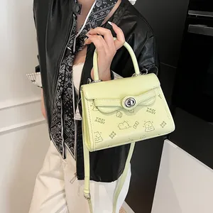 Green contrast small square bag with cartoon bear prints and adjustable shoulder strap