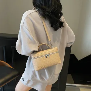 Chic beige quilted square handbag with top handle and crossbody strap for women