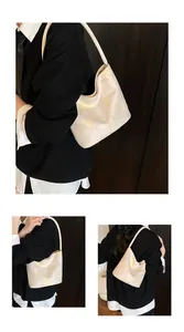 Detailed view of cream bucket bag with floral jacquard texture and sleek shoulder strap