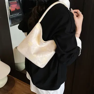 Creamy white jacquard bucket bag with floral texture and semi-moon shape for women
