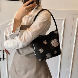 Chic black bucket bag with white floral print, stylish summer shoulder crossbody handbag