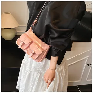 Detail of pink glossy leather tote with double front buckle pockets and adjustable strap