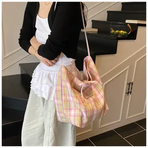Detail of canvas tote bag with pink and yellow plaid pattern and decorative bow tie