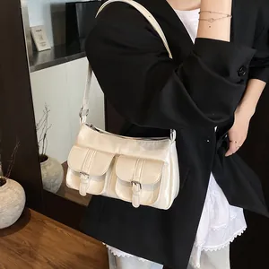 Chic beige patent leather biker tote bag with dual front pockets and adjustable strap