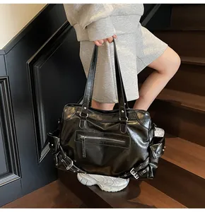 Close-up of black retro Y2K biker tote bag with silver hardware and multi-pocket detail