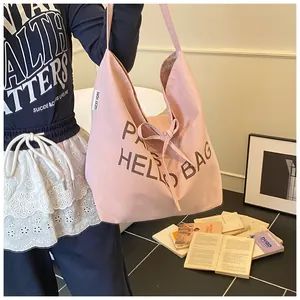 Pink canvas tote bag featuring Hello Bag Paris print and stylish bow ribbon detail