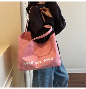 Pink large capacity canvas tote bag featuring white Love you Baby slogan print details