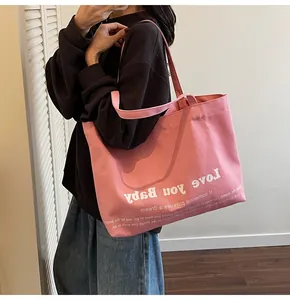 Detailed view of pink canvas tote bag with Love You Baby print and double straps