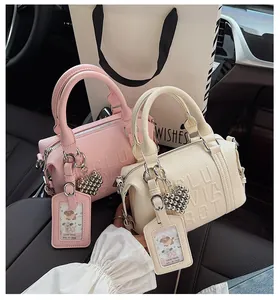 Pink and beige litchi grain boston bags with heart charms and matching card holders