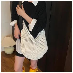 Close-up of woven mesh tote bag with black contrast strap for summer fashion