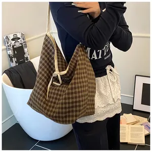 Close-up of brown plaid tote bag showing its soft fabric texture and beige lining detail