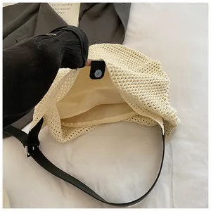 Close-up of woven tote bag showing magnetic snap closure and internal zipper pocket