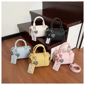 Group shot of colorful Boston bags in pebble leather featuring embossed text and heart charms