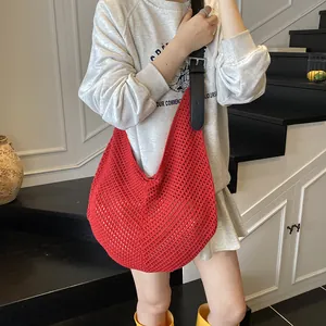 Red crochet woven tote bag with hollow design and adjustable black leather straps