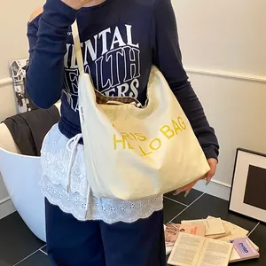 Large cream canvas hobo tote bag with yellow HELLO BAG text and plaid lining