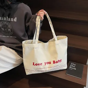 Large beige canvas tote bag with Love You Baby red print for casual daily commuting
