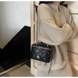 Quilted black leather crossbody bag with silver rhinestones and chain strap detail