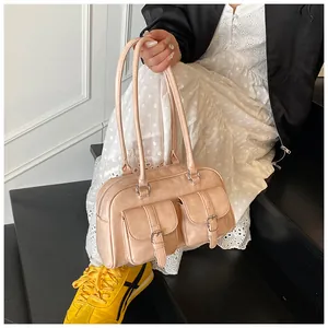 Borsa in ecopelle rosa pallido con due tasche frontali indossata da modella in stile street