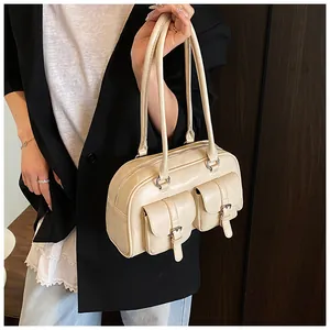 Dettaglio della borsa Boston crema in ecopelle martellata con tasche frontali e fibbia