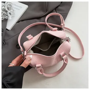 Detailed top view of pink pebble leather bag interior with zipper pocket and lining