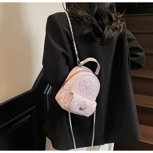 Detail of pink quilted mini backpack with crystal accents and leather chain strap