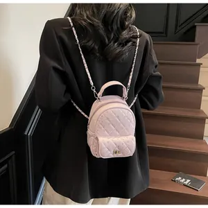 Detail of pink quilted mini backpack with sparkling rhinestones and elegant chain strap