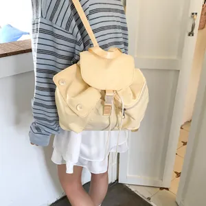 Minimalist nylon backpack in cream yellow featuring a drawstring closure and flap design