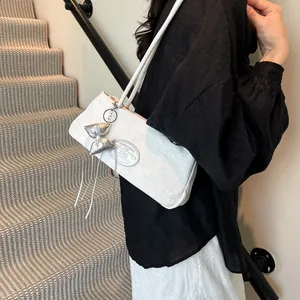 White jacquard underarm bag with silver bow charm and elegant shoulder straps