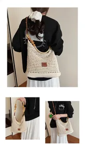 Detail of beige crochet hobo bag with wooden beads and brown leather shoulder strap