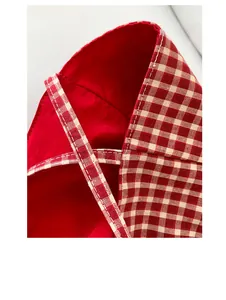 Close-up of red and beige checkered canvas tote bag showing white topstitch detail
