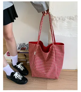 Detail of red checkered canvas tote bag showing large capacity and soft fabric lining